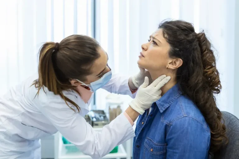 Doctor examines patient's throat