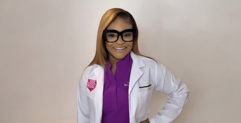 Woman in lab coat smiling